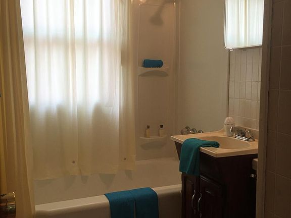Bright bathroom with so much storage and linen closet