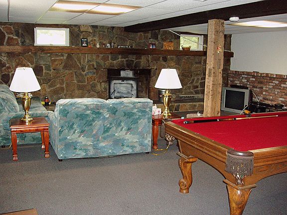 Finnished 24 X 21 lower level family room with a stone fireplace.