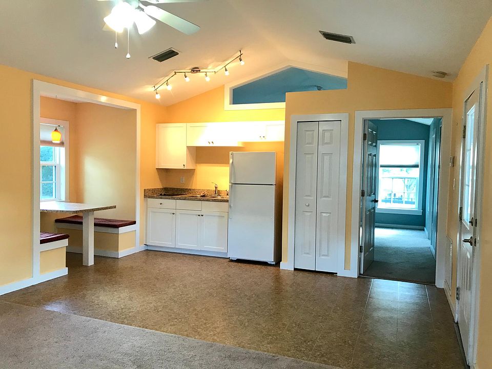 Large Kitchen area with Booth seating with storage underneath. Small 2 burner stove top.