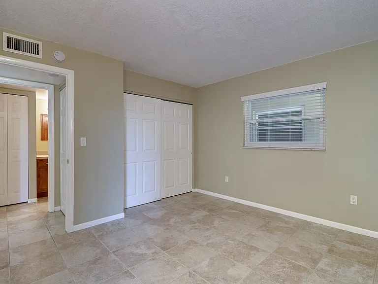 The spacious bedroom has a large closet