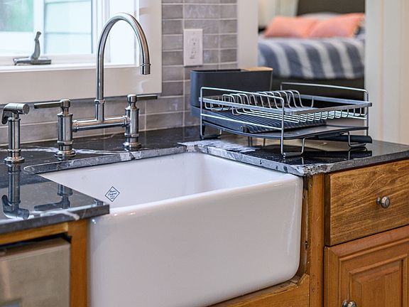 Farmhouse Shaws sink with dishes provided.