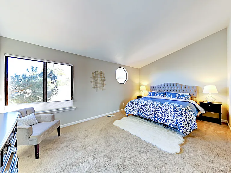 Primary Bedroom with king sized bed & en suite bathroom.