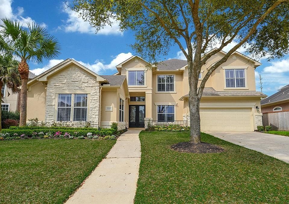 Gorgeous 2-story custom home with attractive stucco and stone elevation and pretty gabled roofing. The home offers 2-car garage with ample space for additional parking. The front lawn is meticulously manicured with mature trees and shrubs complimenti