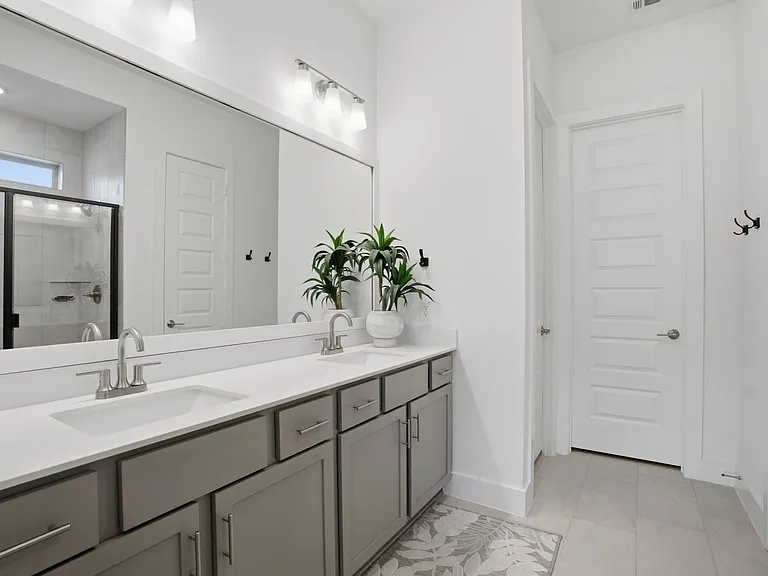 Sparkling clean primary bath has a private commode & nice walk-in closet.