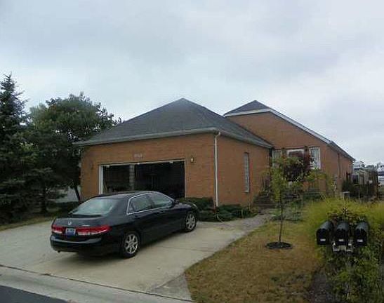 Street View : The spacious two-car garage sports an additional concrete parking space.