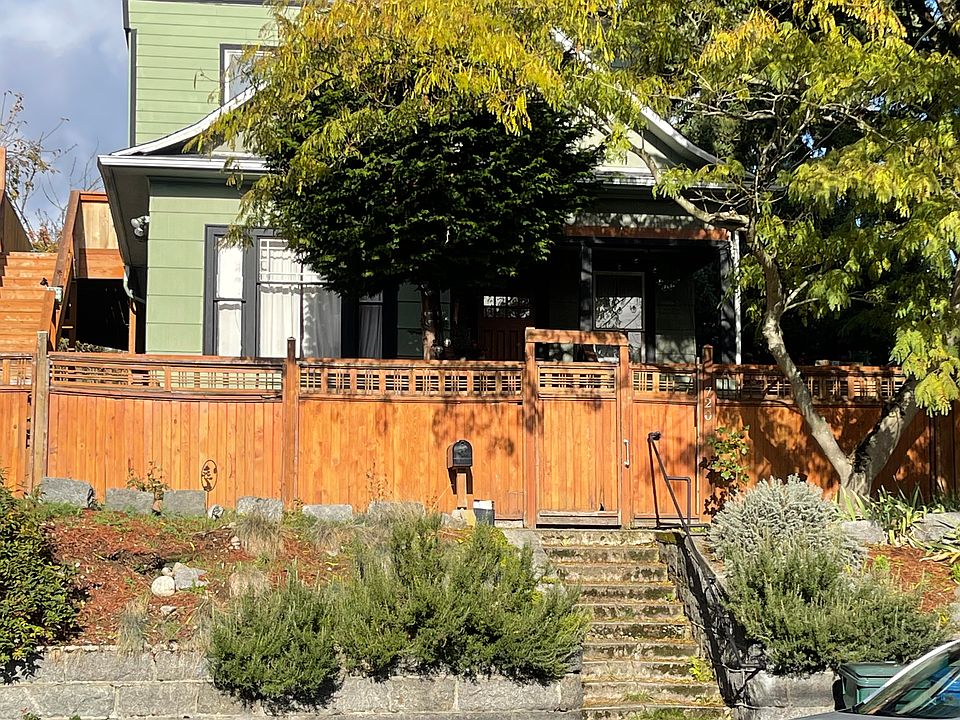 Triplex, Exterior Fence, Unit above stairs on side (sun room window on main floor)