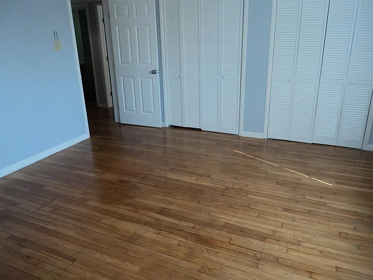 Master bedroom with hardwood floors.