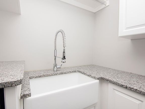 New renovated mudroom with granite counter tops and Italian porcelain apron sink.