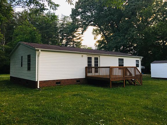 Back of home with large deck