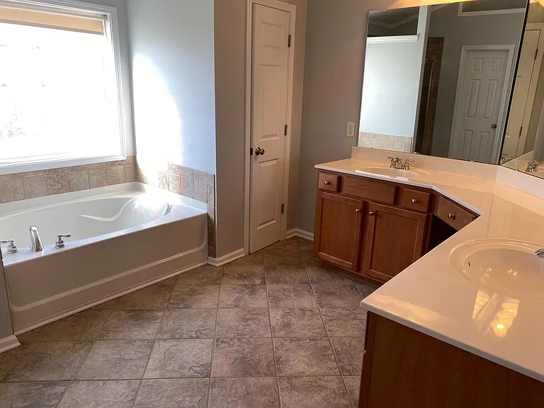 The master bath with garden tub and linen closet.