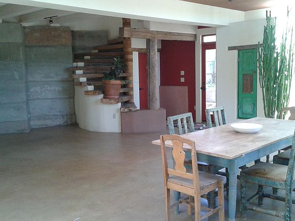 Dining and living room with open 2 story ceilings. Polished concrete floors.