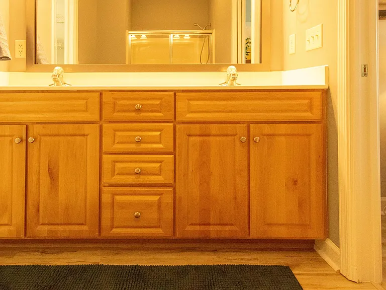 Master bath with double vanity and ample cupboard space.