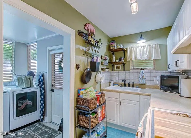 kitchen into laundry area with space for a small office or storage