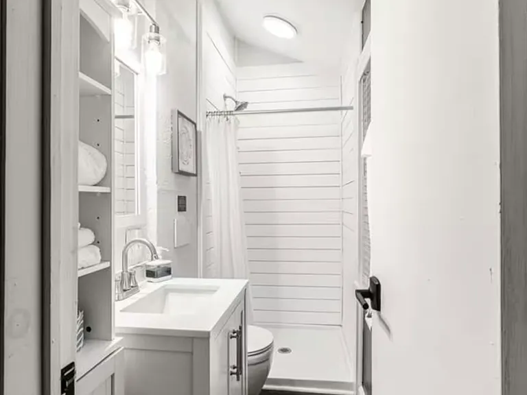 Bathroom with shower, toilet, sink, window, shelving unit
