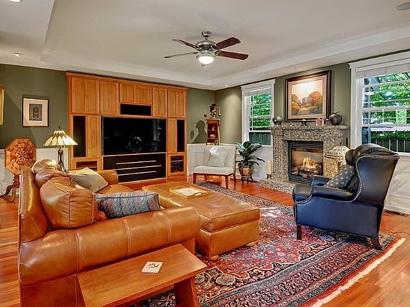 Massive great room features built ins, gas fireplace, crown molding, coffered ceilings and hardwood floors.