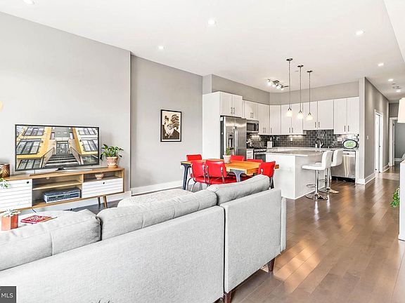 Open floor plan, showing views from the windows of the living room, facing the kitchen.