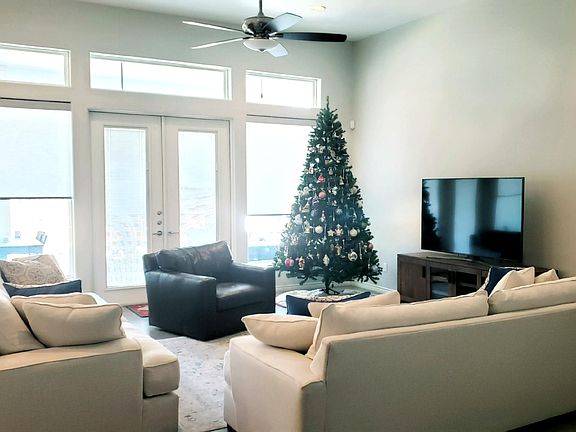 Spacious great room can hold over-sized furniture with lots of natural light and french doors leading to the back patio.