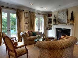 Beautiful formal living room has hardwood floors, fireplace, built-ins and overlooks professionally 