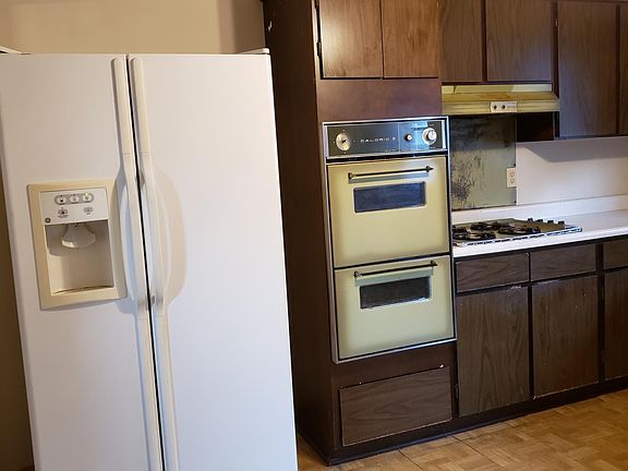 kitchen with a side by side refrigerator, vintage oven and broiler
