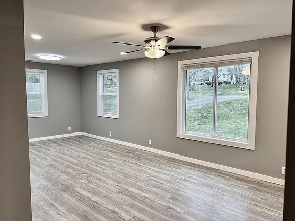 View from the bedrooms and baths to the living room. Recessed lighting in the living room and lots of outlets throughout!