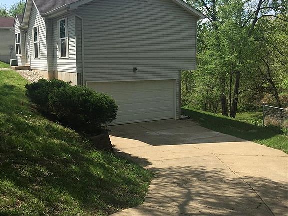 Long driveway leading to 2 car garage...great for additional parking!