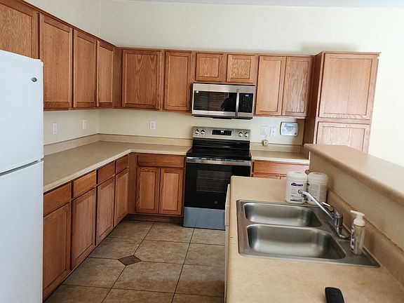 Kitchen with new microwave and stove.