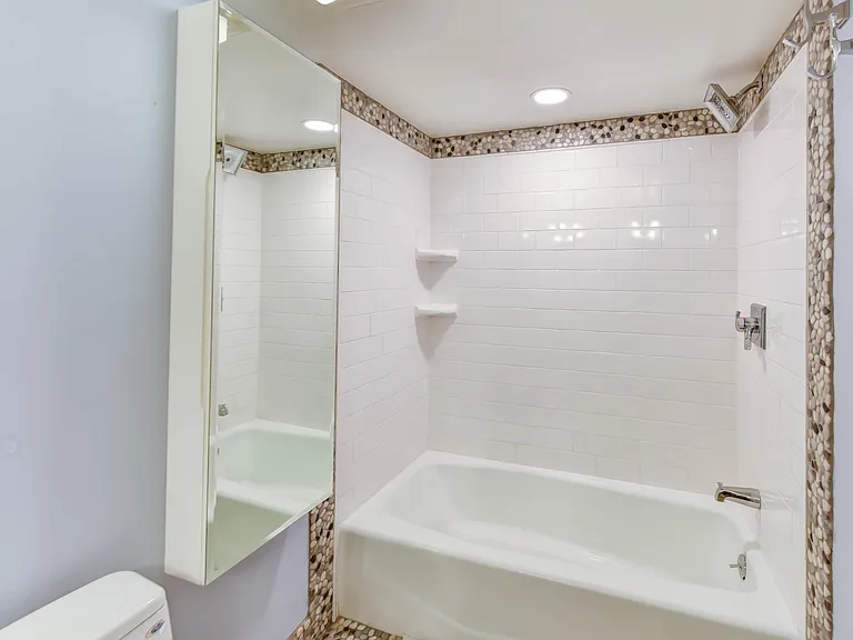 Renovated hall bath with extra large medicine cabinet.