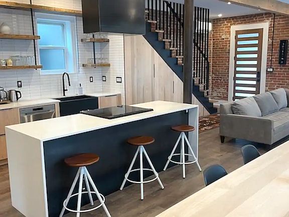 kitchen and bar seating area facing toward the entrance