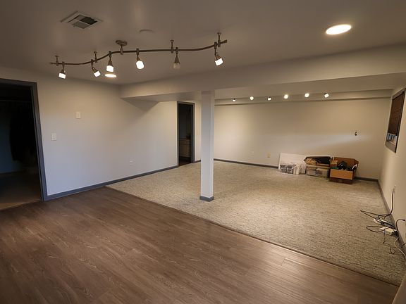 Walkout basement with sliding glass door and large windows, as well as storage and a full bathroom