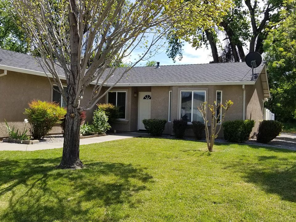 You can see the big shade trees in back, smaller shade trees on the SW (right side), big shade tree in front, three car garage a
