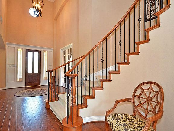 Look at the wrought iron staircase and upgraded handscrapped hardwood floors