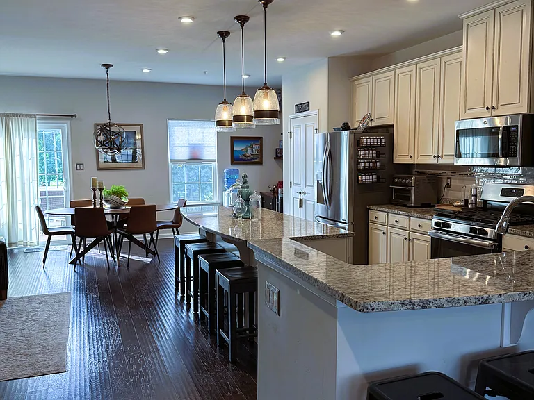 View from the family room into the kitchen and dining areas