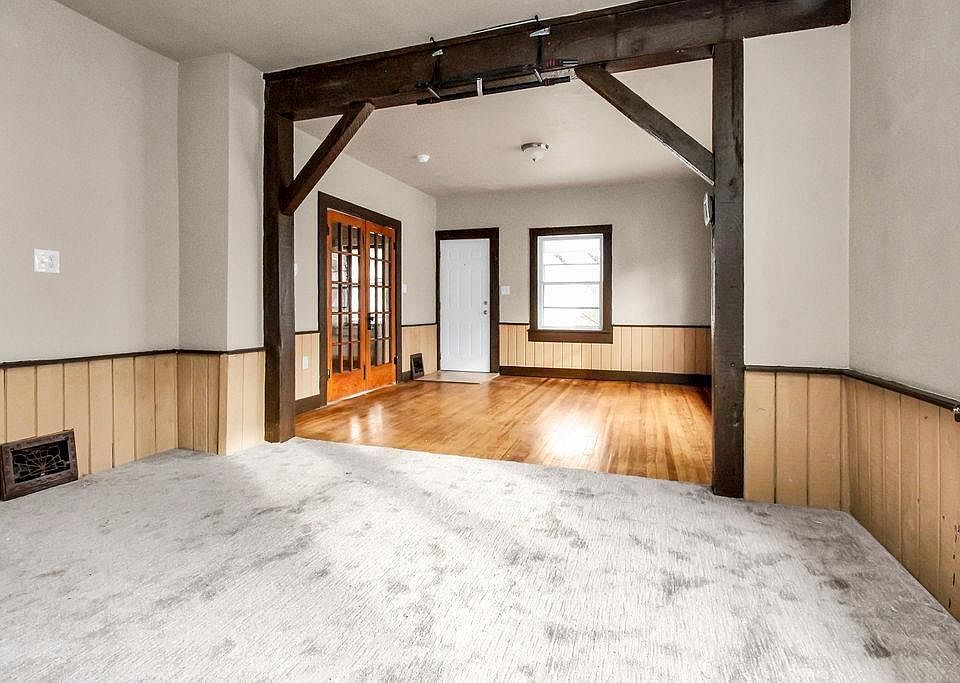 This is a pic of the front door (white) and the French doors that lead to master bedroom. The hardwood floors could be a living room or the carpeted area could be either a living or dining room.