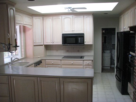 Open kitchen with sky light and ceiling fan