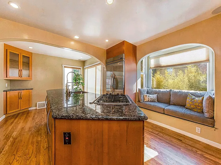 Chef's kitchen on main level overview, built-in window nook seating.