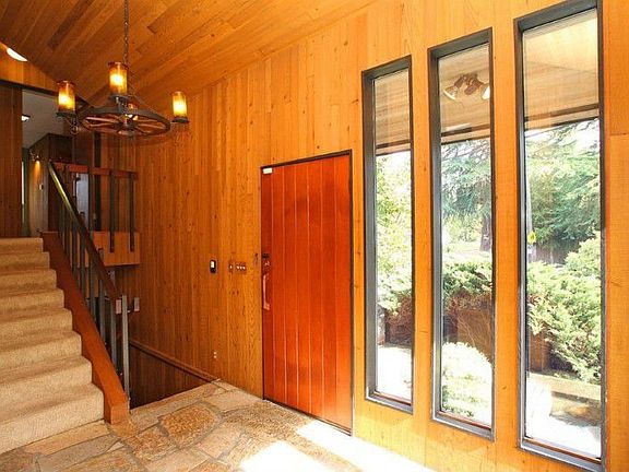 Bright, welcoming entryway with steps up to master suite.