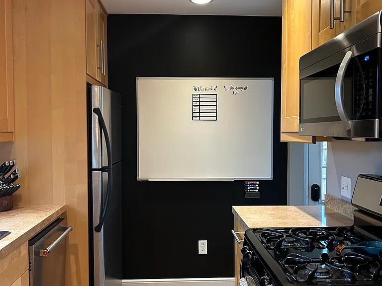Chalk wall with a white board. Perfect for easily keeping track of your grocery list!