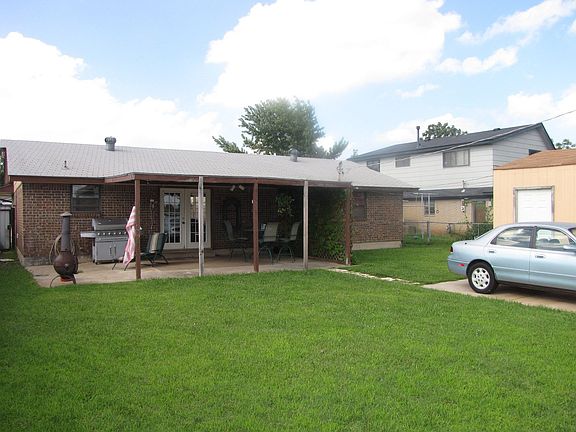 Covered patio in the backyard .