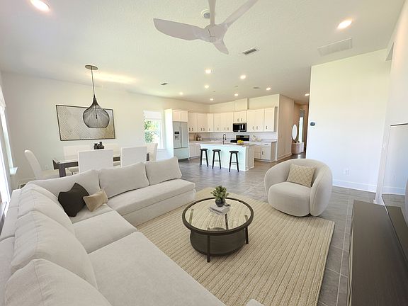 Virtually staged. The spacious great room has a comfy feel and space for everyone.