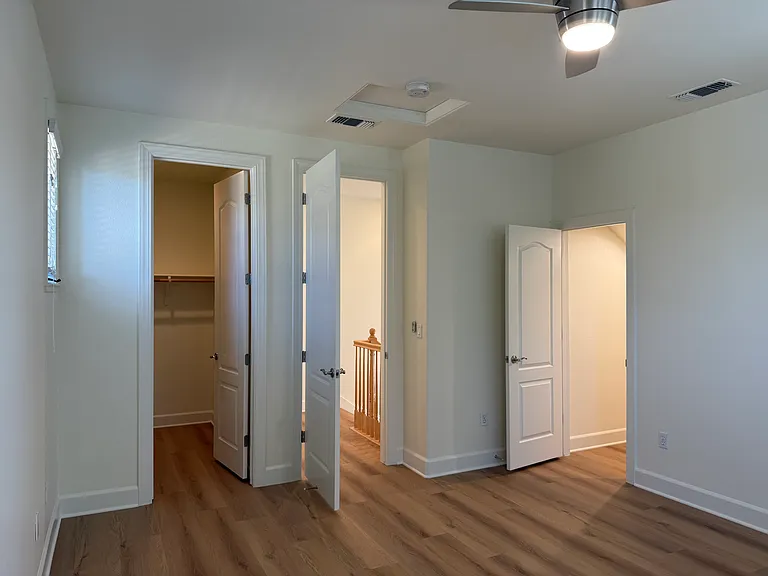 Fourth bedroom is on the third floor with a bathroom across the hallway. The fourth bedroom features a ceiling fan with 2 walk-in closets.