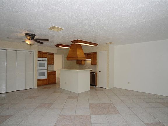 LARGE ISLAND KITCHEN OPEN TO FAMILY ROOM WITH TILE FLOORING