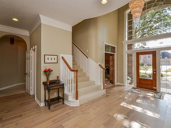 Enter into your two story foyer. Large picture window above the door allows plenty of natural light into the home. The beautiful new hardwoods were just installed in late 2018. Absolutely stunning.