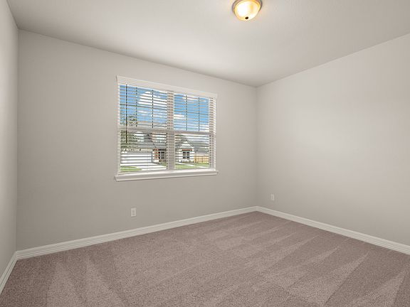The third bedroom features plush carpet, fresh paint, closet, and a large window that lets in plenty