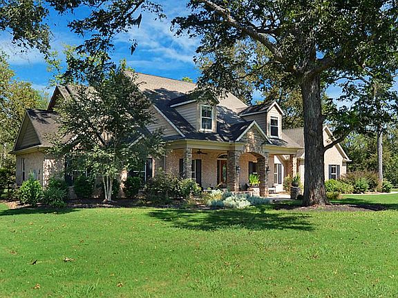 Set gently back off the road, a majestic pecan tree serves as a focal point. An abundance of privacy