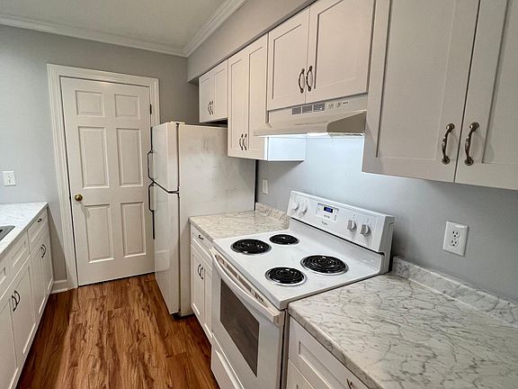 Updated kitchen with new soft close cabinets and new countertops.