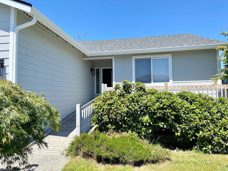 Front of the house with ramped entry way and front deck