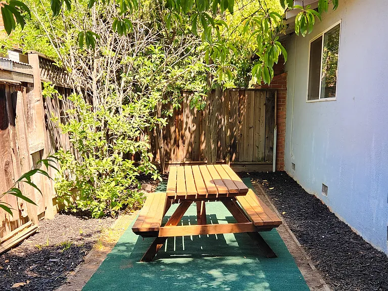 Picnic table on the side of the house
