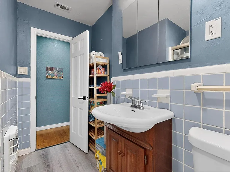 A bright bathroom with a modern vanity and toilet
