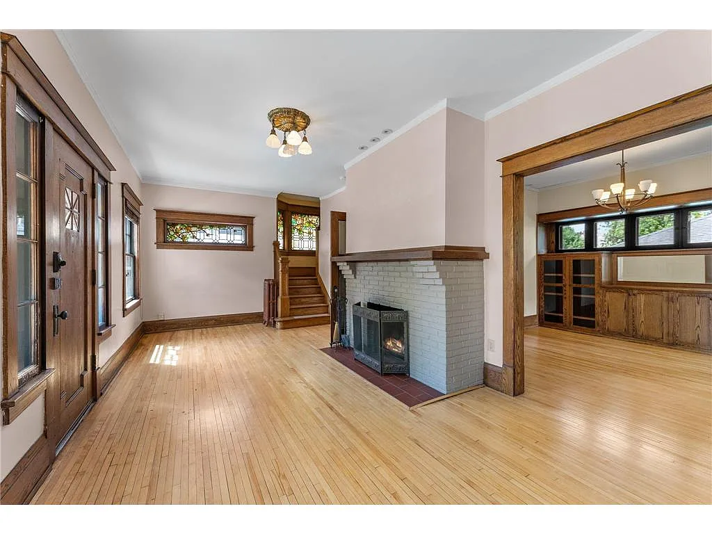The living room is anchored by a gorgeous wood burning fireplace! - 1458 W 33rd St