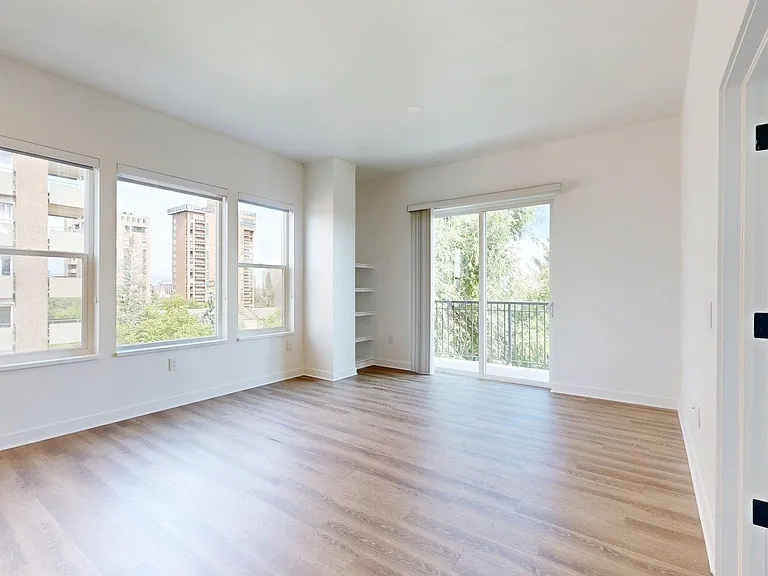 Apartment living room with wood style floor and balcony.